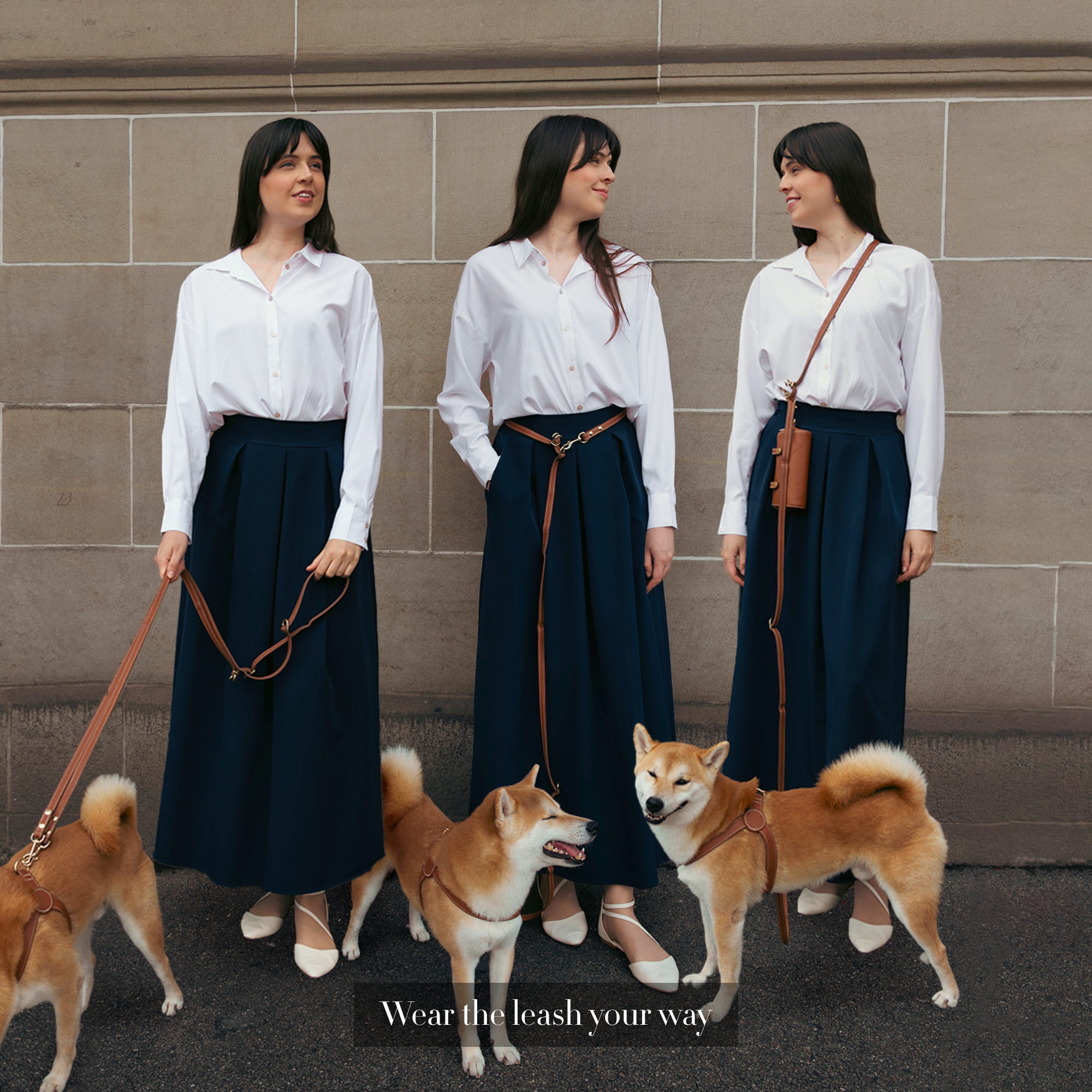 Woman in a white shirt and dark skirt wearing a dog leash around the waist or crossbody or hand-held with a dog. #lang_en