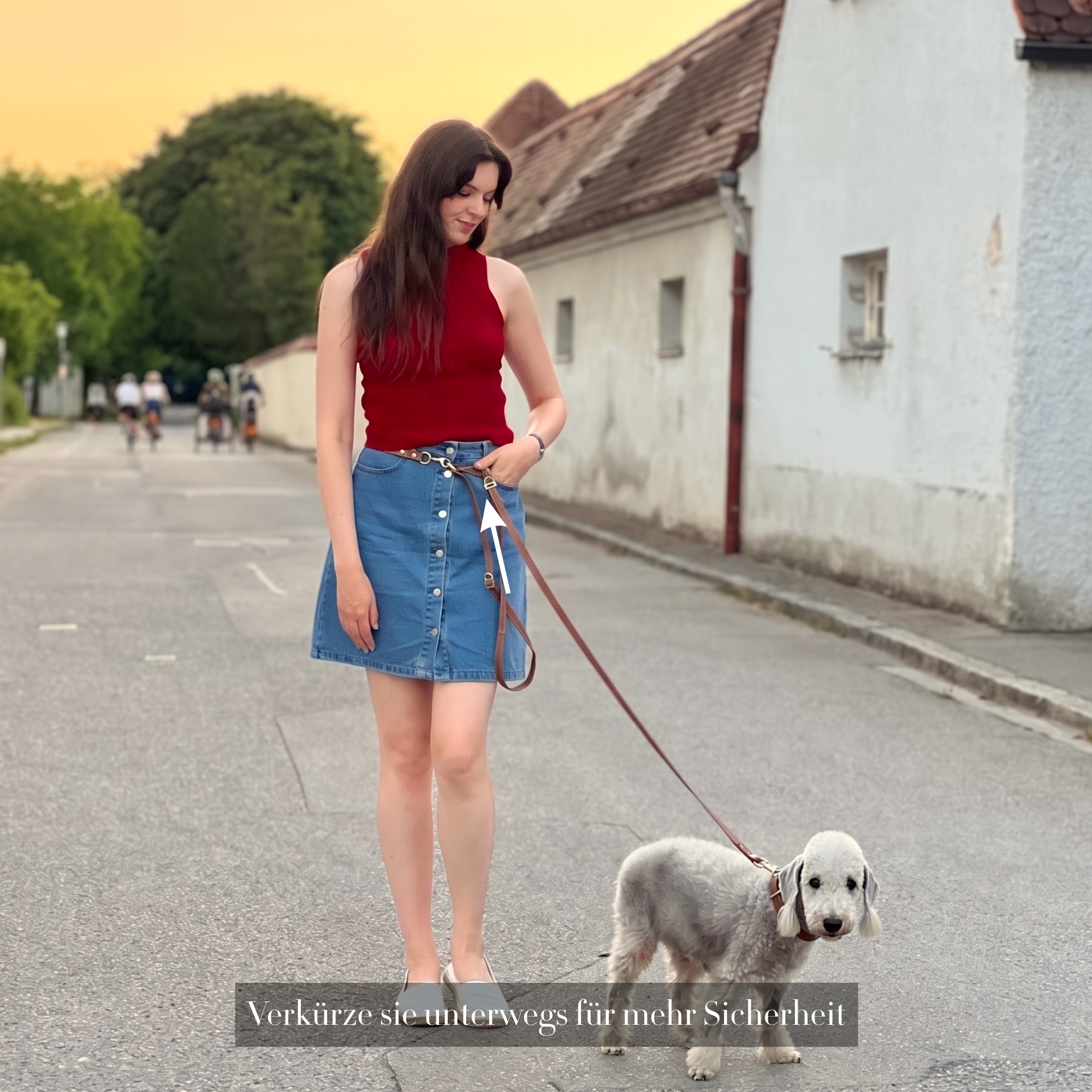 Woman in red top and blue skirt walking a dog on a street. #lang_de