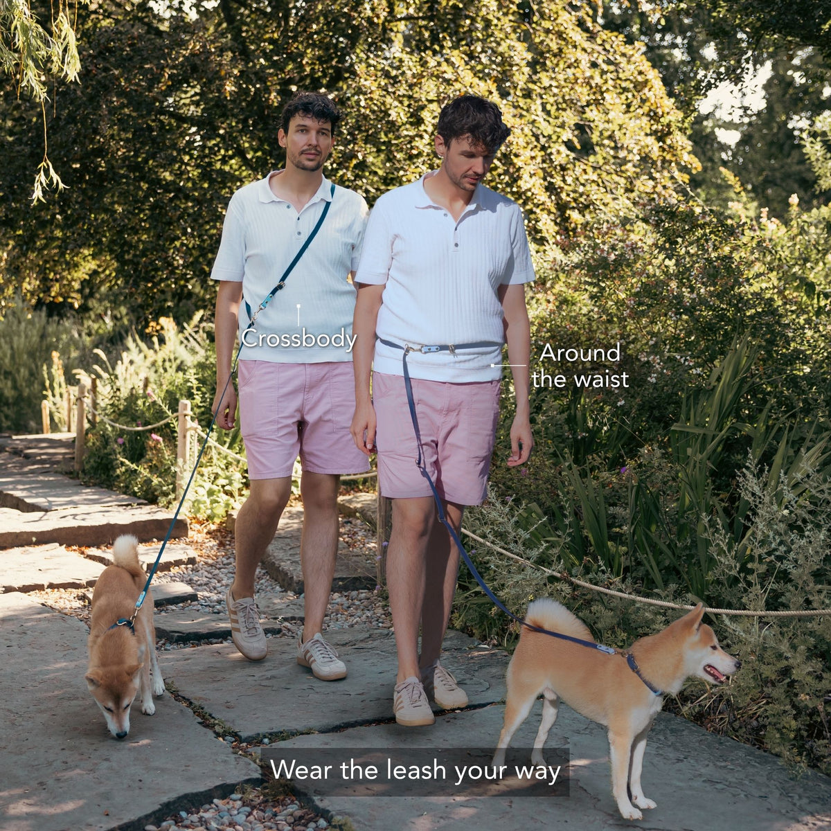 Two men walking dogs on a stone path in a garden, demonstrating crossbody and around-the-waist leash styles. Text overlays read 'Crossbody', 'Around the waist', and 'Wear the leash your way'. #lang_en